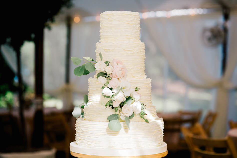 The cake is accented with flowers, Wadmalaw Island, South Carolina Kate Timbers Photography. http://katetimbers.com #katetimbersphotography // Charleston Photography // Inspiration