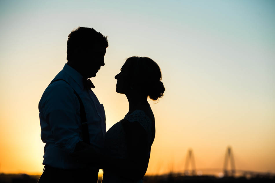 Bride and groom stand near Ravenel Bridge at sunset, Alhambra Hall, Mt Pleasant, South Carolina Kate Timbers Photography. http://katetimbers.com #katetimbersphotography // Charleston Photography // Inspiration