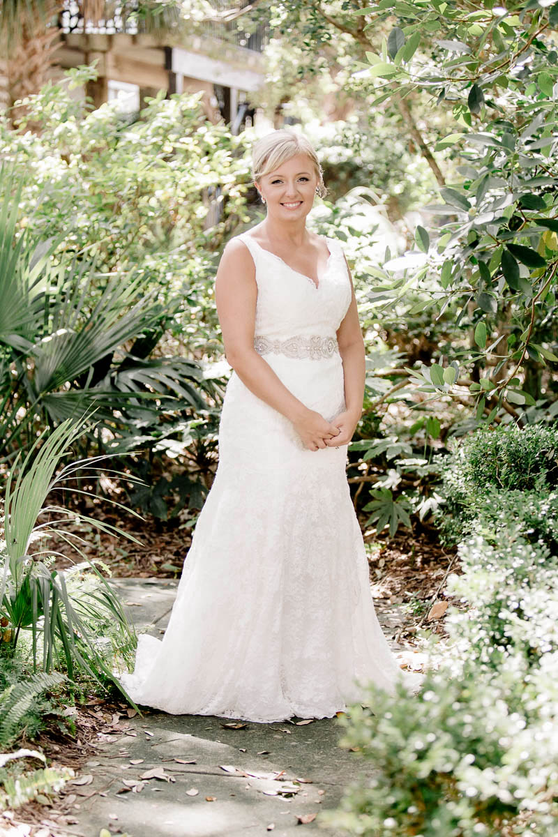 Bride stands among palm trees, Wild Dunes, Charleston, South Carolina Kate Timbers Photography. http://katetimbers.com #katetimbersphotography // Charleston Photography // Inspiration