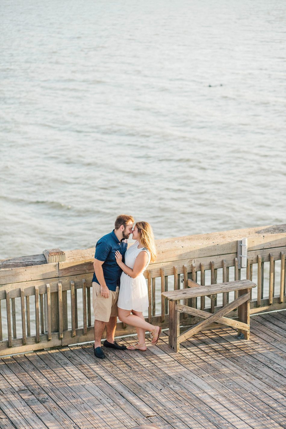 Engaged Couple kiss on pier, Folly beach in Charleston, South Carolina Kate Timbers Photography. http://katetimbers.com #katetimbersphotography // Charleston Photography // Inspiration