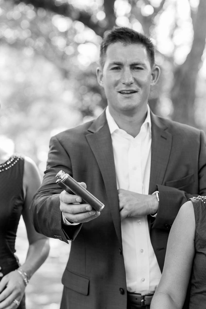 Groomsman holds a flask in old Mt Pleasant, South Carolina Kate Timbers Photography. http://katetimbers.com #katetimbersphotography // Charleston Photography // Inspiration