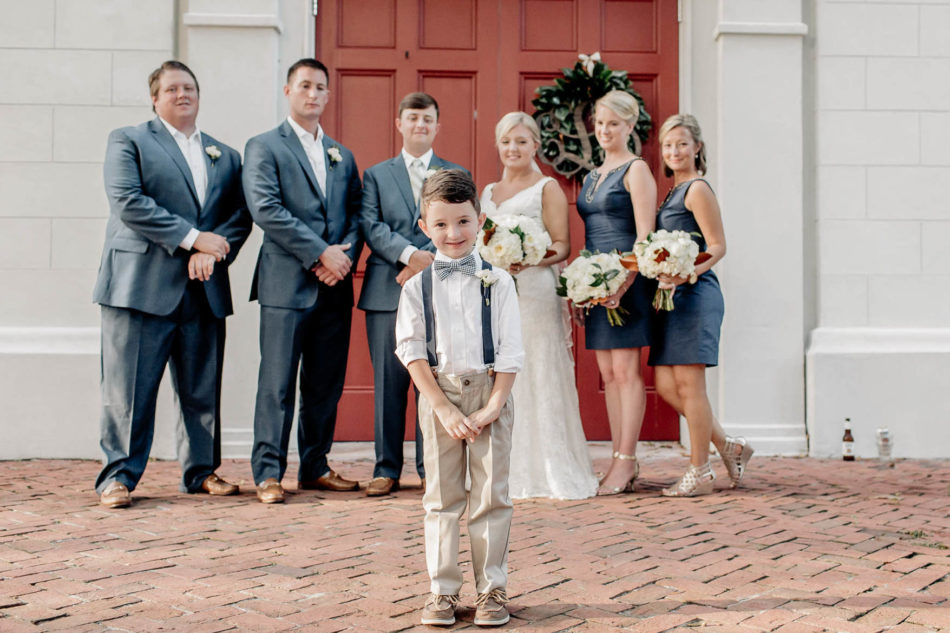 Ringbearer stands in forefront with wedding party behind him, Coleman Hall, Mt Pleasant, South Carolina Kate Timbers Photography. http://katetimbers.com #katetimbersphotography // Charleston Photography // Inspiration
