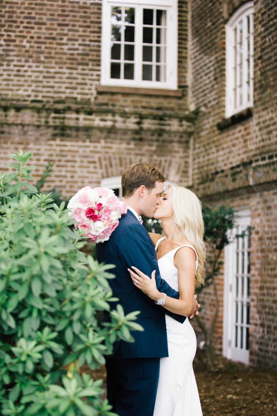 Bride and groom snuggle at the Rice Mill Building, Charleston, South Carolina Kate Timbers Photography. http://katetimbers.com #katetimbersphotography // Charleston Photography // Inspiration