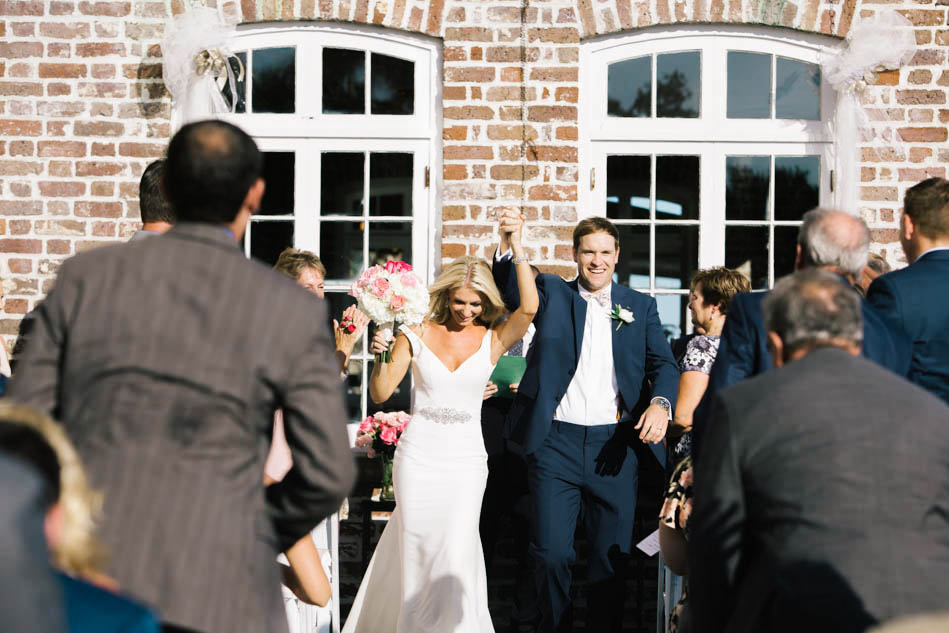 Bride and groom walk down the aisle, Rice Mill Building, Charleston, South Carolina Kate Timbers Photography. http://katetimbers.com #katetimbersphotography // Charleston Photography // Inspiration