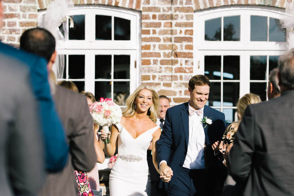 Bride and groom walk down the aisle, Rice Mill Building, Charleston, South Carolina Kate Timbers Photography. http://katetimbers.com #katetimbersphotography // Charleston Photography // Inspiration