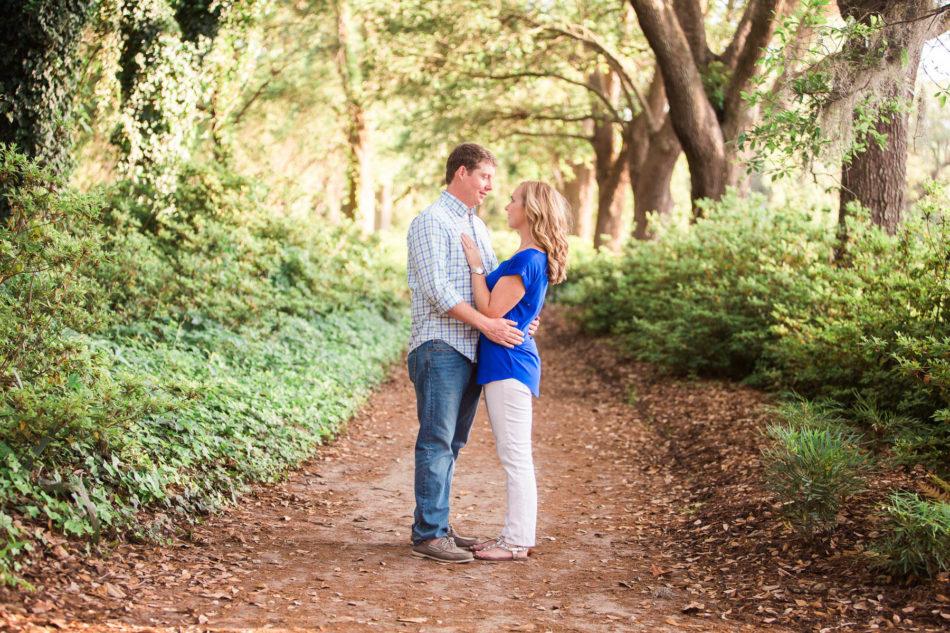 Engaged couple stand in pathway of oak trees, Hampton Park, Charleston, South Carolina Kate Timbers Photography. http://katetimbers.com #katetimbersphotography // Charleston Photography // Inspiration