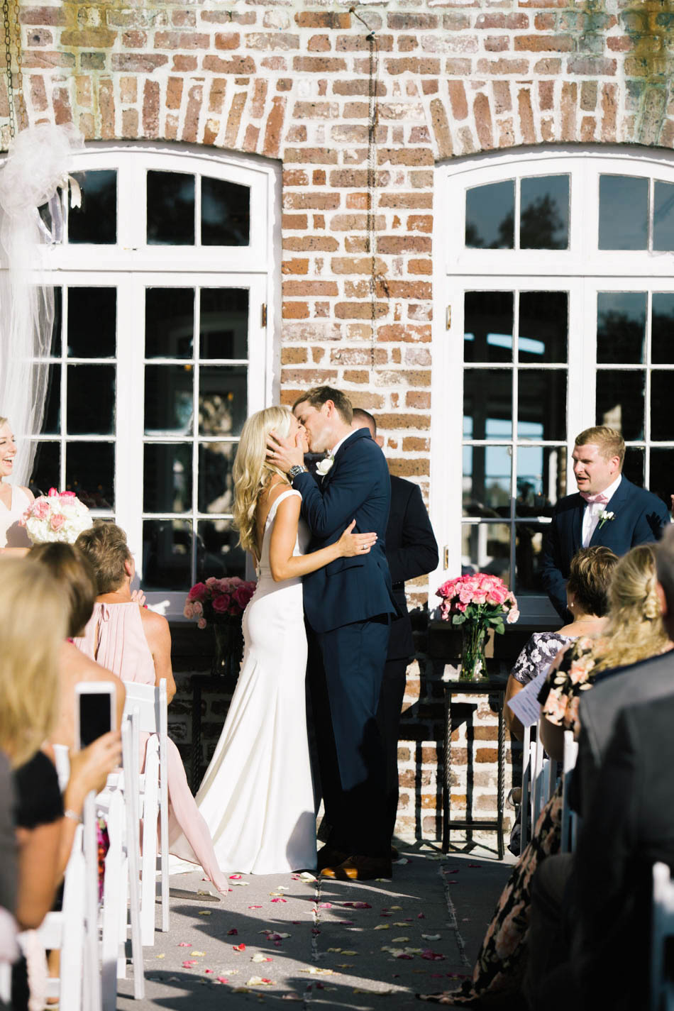 Bride and groom kiss, Rice Mill Building, Charleston, South Carolina Kate Timbers Photography. http://katetimbers.com #katetimbersphotography // Charleston Photography // Inspiration