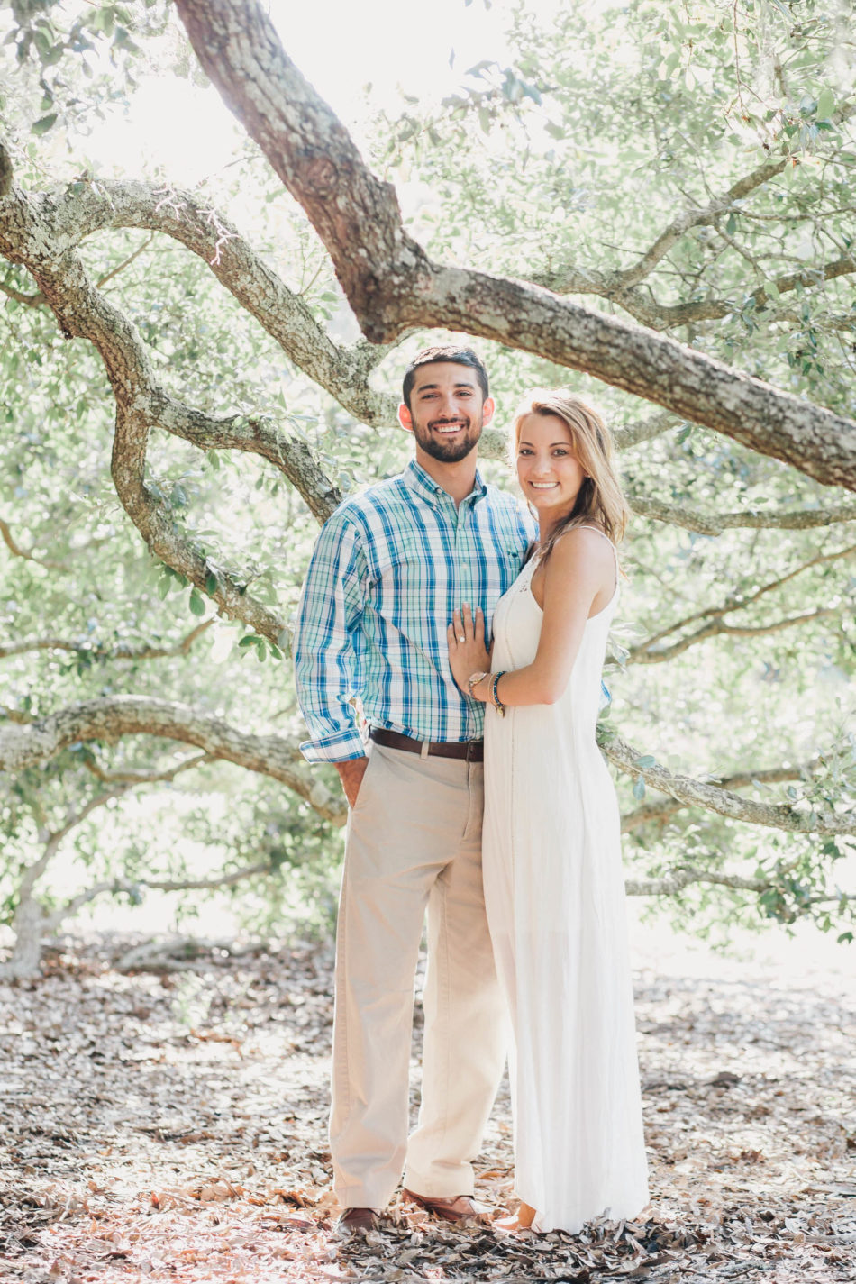 Engaged couple posing underneath oak tree, Hampton Park, Charleston, South Carolina Kate Timbers Photography. http://katetimbers.com #katetimbersphotography // Charleston Photography // Inspiration