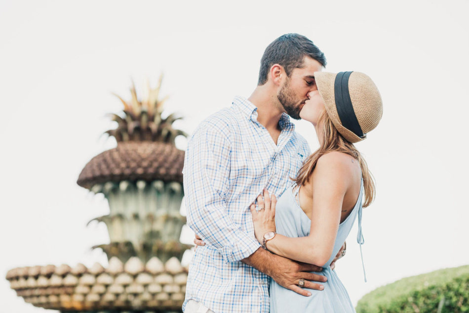 Engaged couple cuddling by the Pineapple Fountain, Waterfront Park, Charleston, South Carolina Kate Timbers Photography. http://katetimbers.com #katetimbersphotography // Charleston Photography // Inspiration