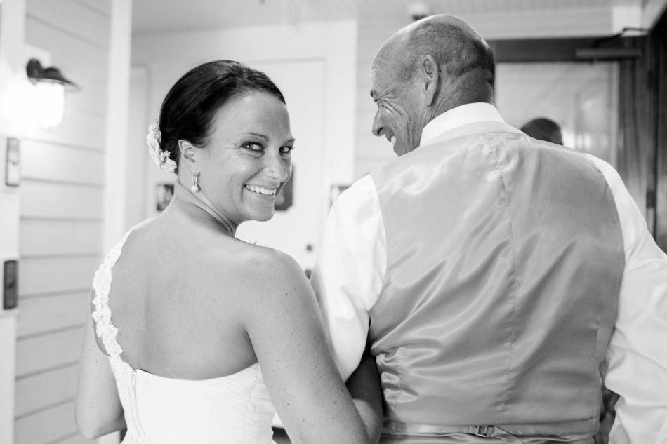 Bride and father share a fun moment before walking down the aisle at the Charleston Fish House. www.katetimbers.com