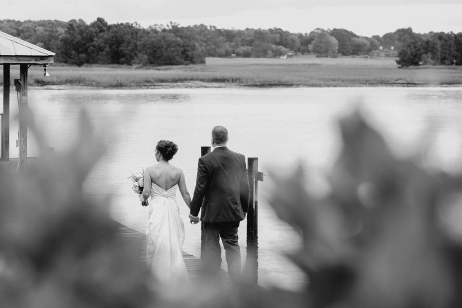 Bride and groom stand on dock, Old Wide Awake Plantation, Charleston, South Carolina. Kate Timbers Photography. katetimbers.com