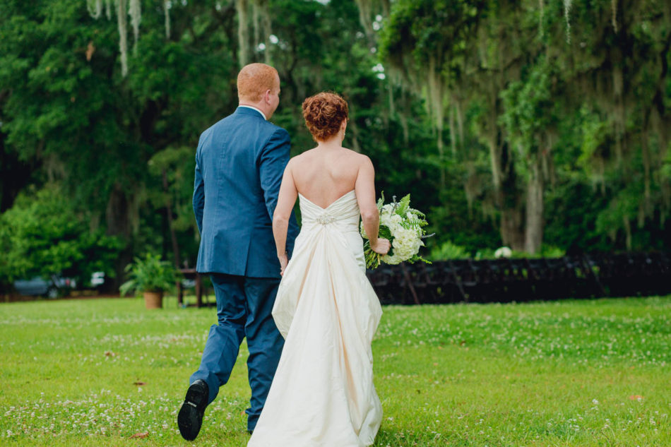 Bride and groom walk to oak tree, Old Wide Awake Plantation, Charleston, South Carolina. Kate Timbers Photography. katetimbers.com