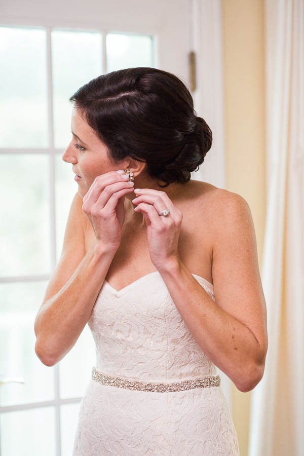 Bride gets earrings on, Isle of Palms, Charleston, SC, Hurricane Joaquin. Kate Timbers Photography. katetimbers.com