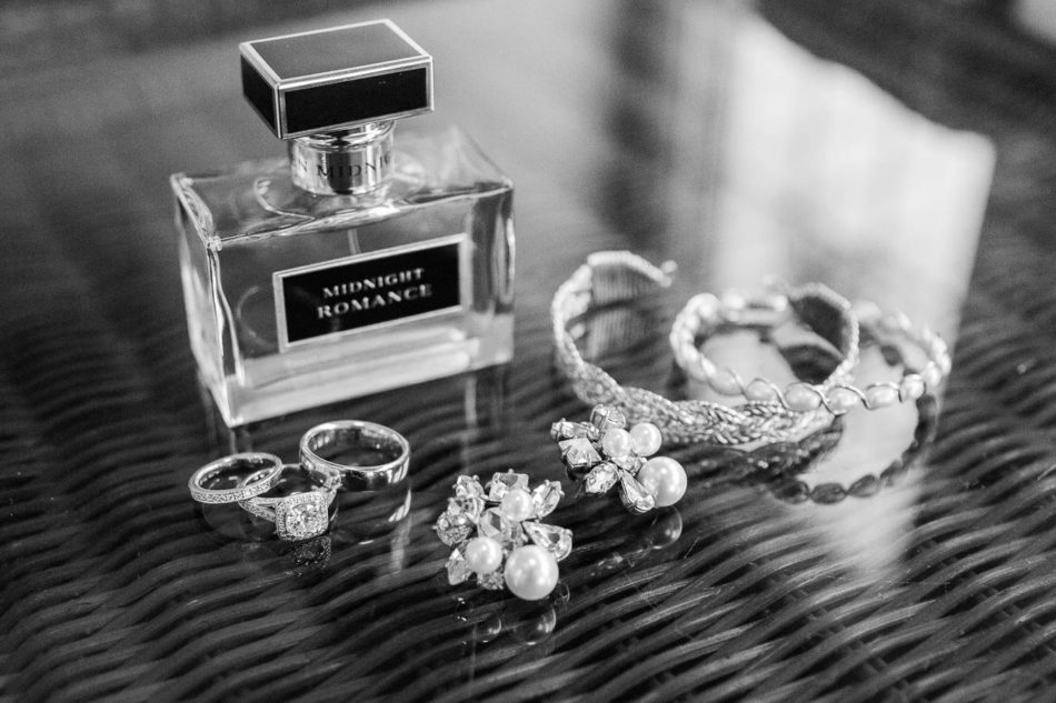Jewelry sit on table with Midnight Romance perfume bottle, Isle of Palms, Charleston, SC, Hurricane Joaquin. Kate Timbers Photography. katetimbers.com