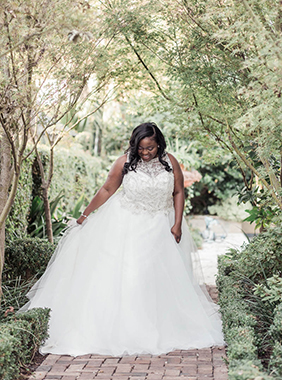 Bride stands in garden, Downtown Private Estate, Charleston. Kate Timbers Photography. http://katetimbers.com