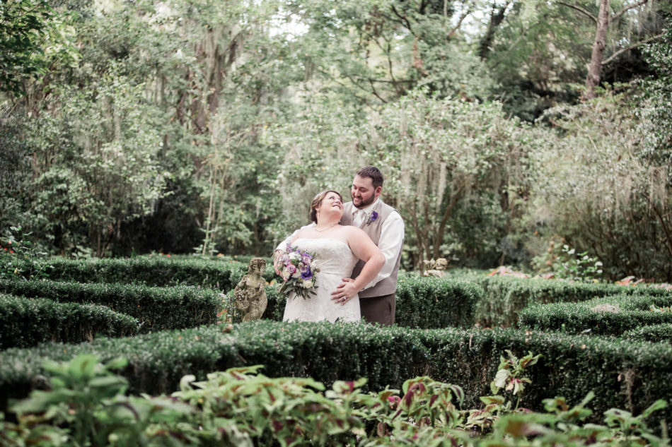 Bride and groom stand in the garden, Magnolia Plantation. Kate Timbers Photography. http://katetimbers.com