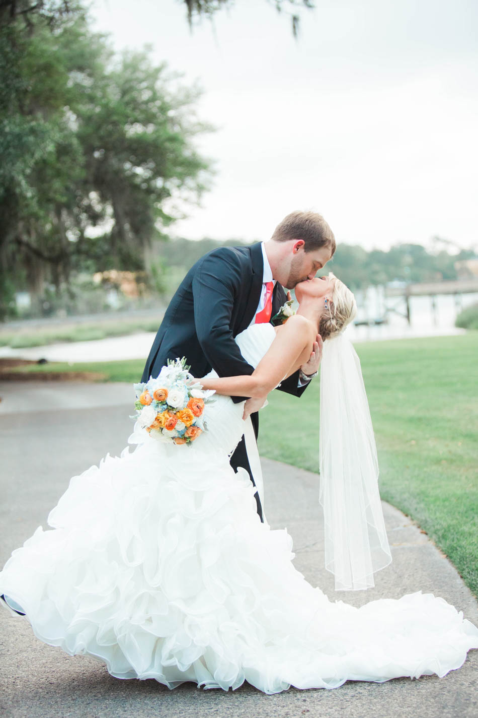 Bride and groom kiss in field, Dunes West Golf and River Club, Mt Pleasant, South Carolina. Kate Timbers Photography. http://katetimbers.com