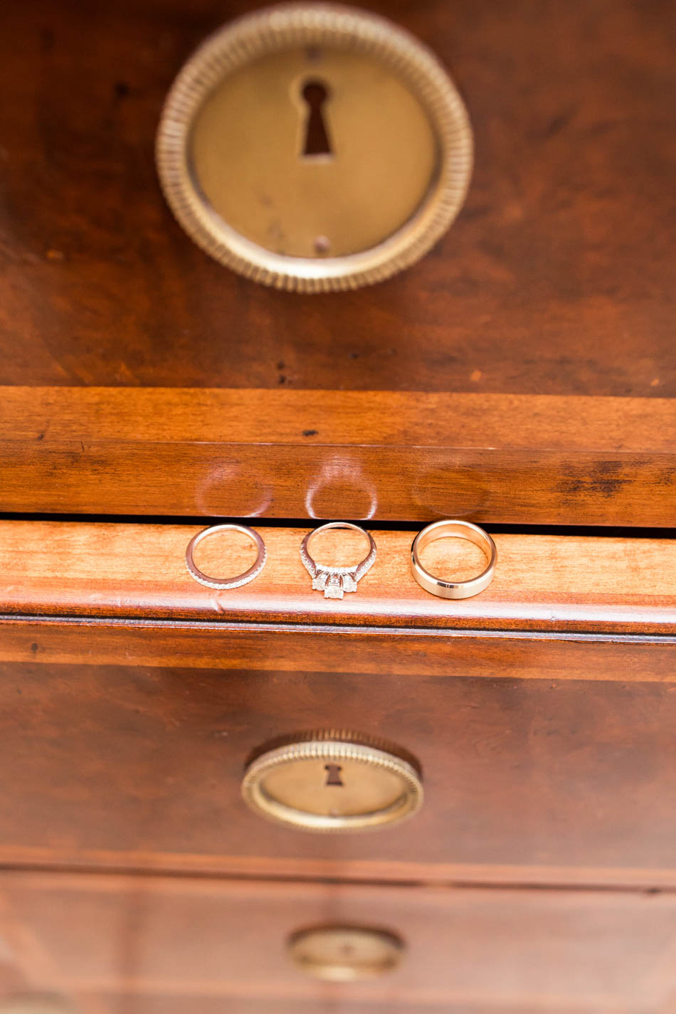 Rings lay on wooden chest drawer, Daniel Island Club, Charleston, South Carolina. Kate Timbers Photography. http://katetimbers.com