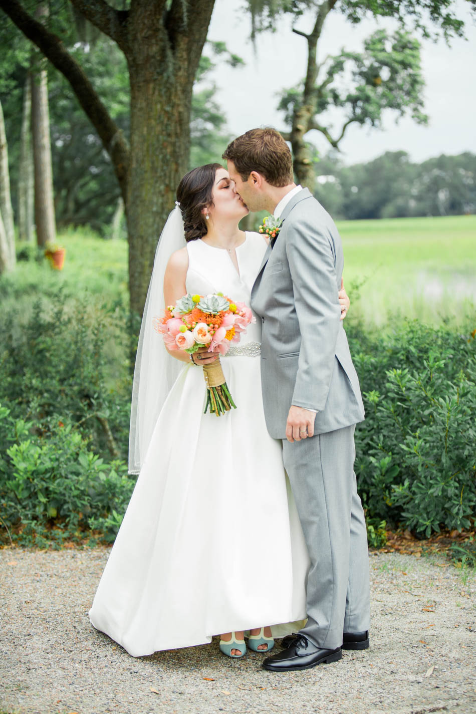 Bride and groom kiss by the marsh, I'on Creek Club, Mt Pleasant, South Carolina. Kate Timbers Photography. http://katetimbers.com