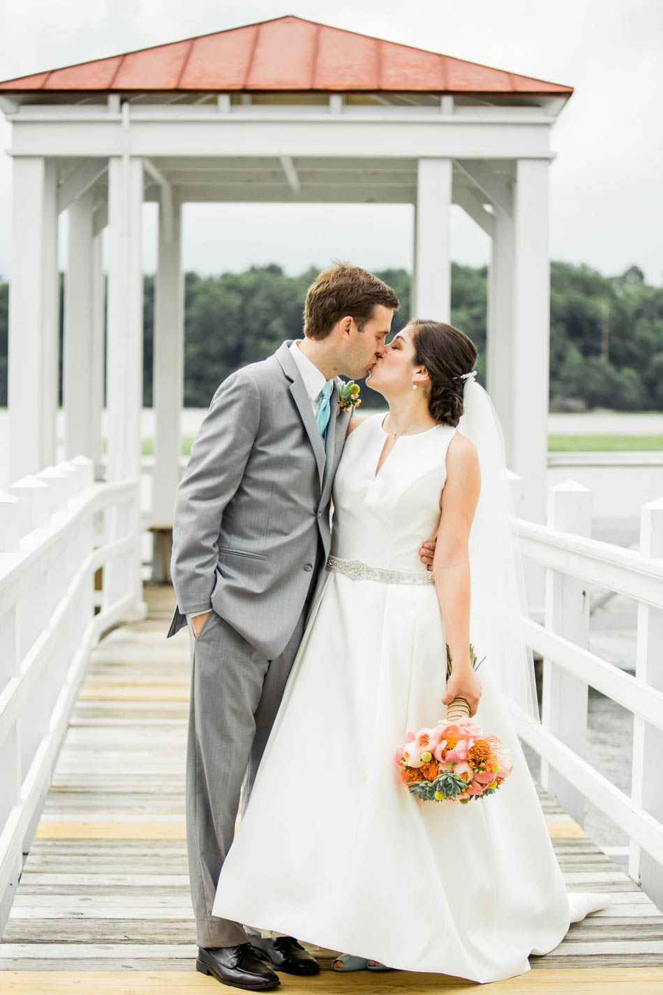 Bride and groom stand on dock, I'on Creek Club, Mt Pleasant, South Carolina. Kate Timbers Photography. http://katetimbers.com