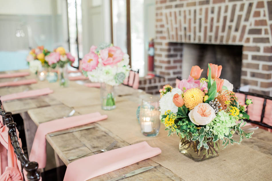 Orange, yellow, and pink floral arrangement is placed on each table, I'on Creek Club, Mt Pleasant, South Carolina. Kate Timbers Photography. http://katetimbers.com