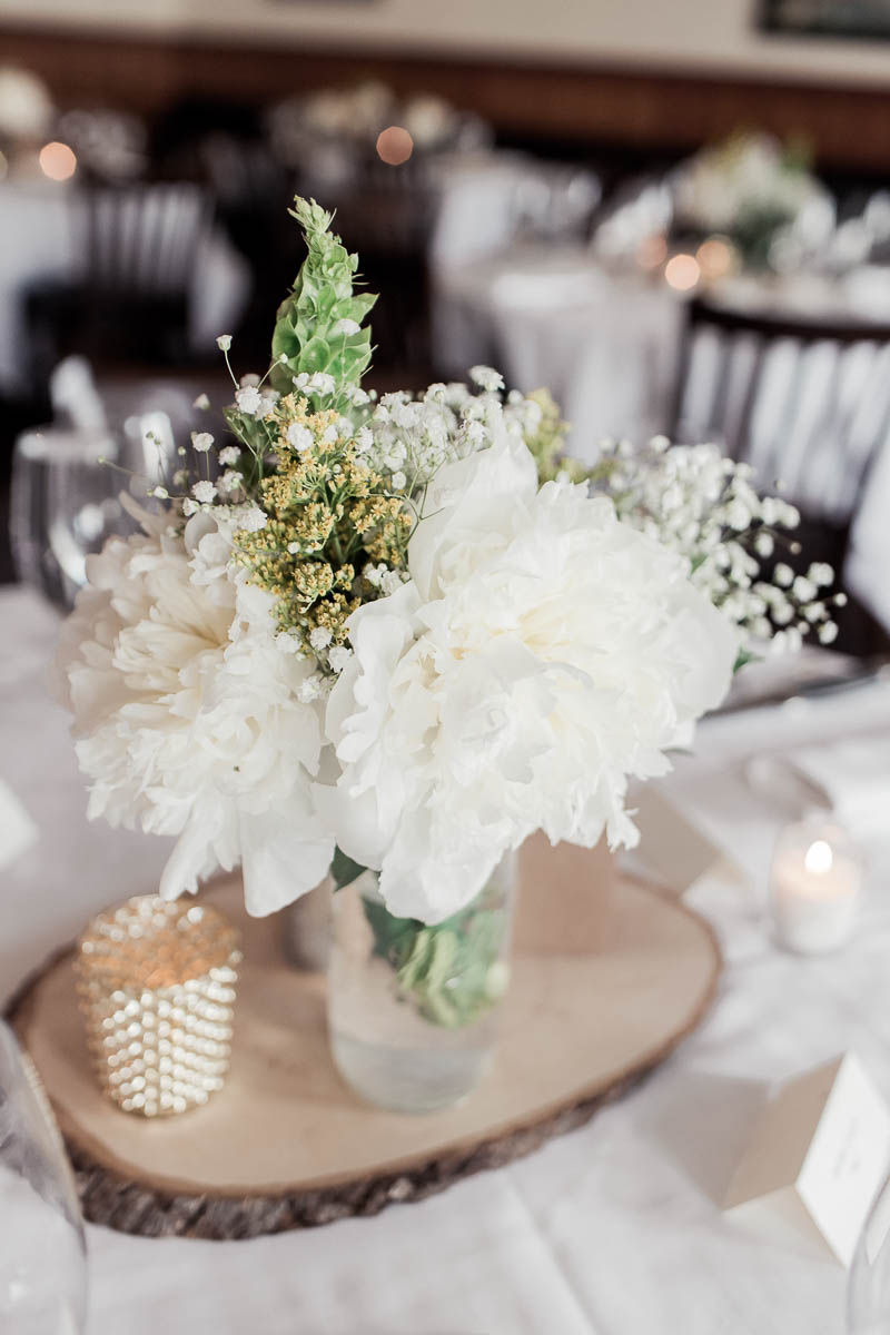 Flower centerpieces are accented with rustic wood details, Stars Rooftop & Grill Room, Charleston, South Carolina. Kate Timbers Photography. http://katetimbers.com
