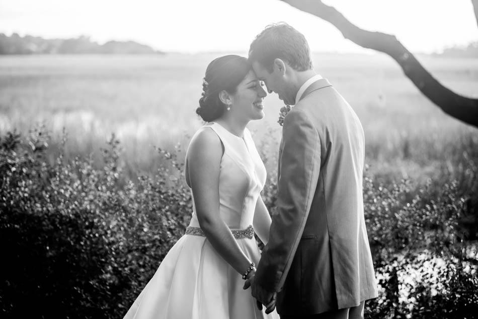 Bride and groom stand at sunset by the marsh, I'on Creek Club, Mt Pleasant, South Carolina. Kate Timbers Photography. http://katetimbers.com