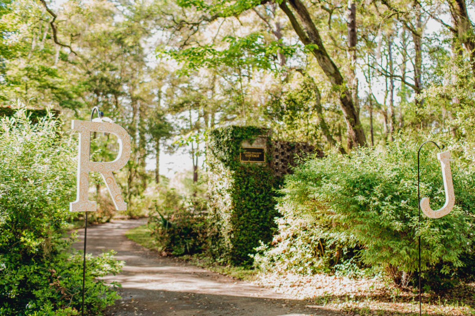 Bride and groom's initials hang by entrance of ceremony, Brookgreen Gardens, Murrells Inlet, South Carolina. Kate Timbers Photography. http://katetimbers.com