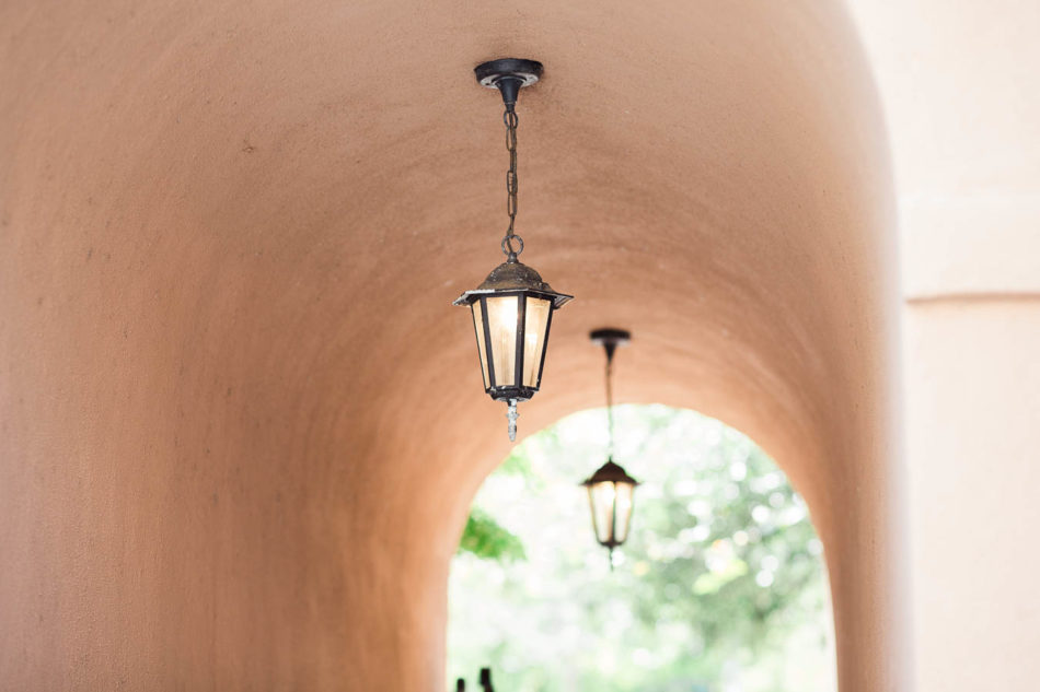 Lanterns hang in archway, Jacob Bond House, Charleston, South Carolina. Kate Timbers Photography. http://katetimbers.com