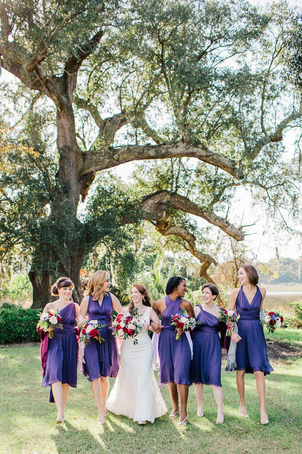 Bride and bridesmaids walk by oak tree, Boone Hall Plantation, Charleston, South Carolina. Kate Timbers Photography. http://katetimbers.com #katetimbersphotography // Charleston Photography // Inspiration