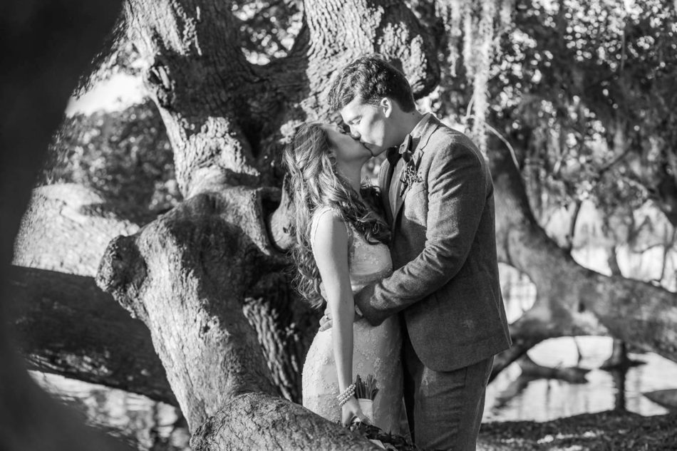 Bride and groom stand in garden at sunset, Boone Hall Plantation, Charleston, South Carolina. Kate Timbers Photography. http://katetimbers.com #katetimbersphotography // Charleston Photography // Inspiration