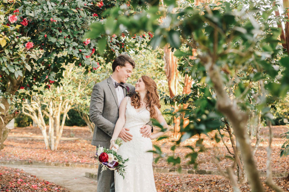 Bride and groom stand in garden at sunset, Boone Hall Plantation, Charleston, South Carolina. Kate Timbers Photography. http://katetimbers.com #katetimbersphotography // Charleston Photography // Inspiration