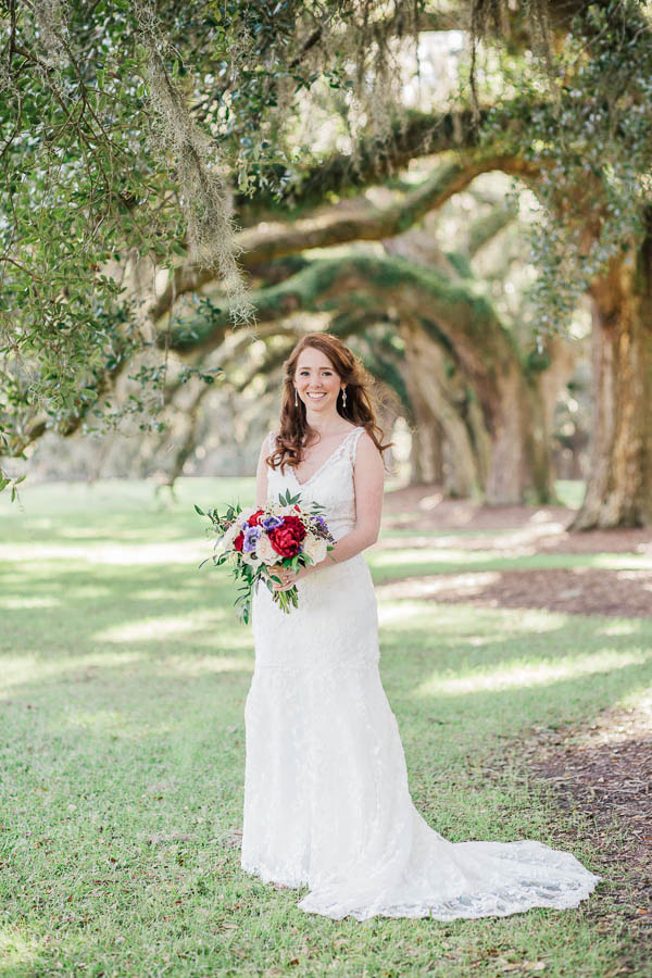 Bride stands under avenue of oaks, Boone Hall Plantation, Charleston, South Carolina. Kate Timbers Photography. http://katetimbers.com #katetimbersphotography // Charleston Photography // Inspiration