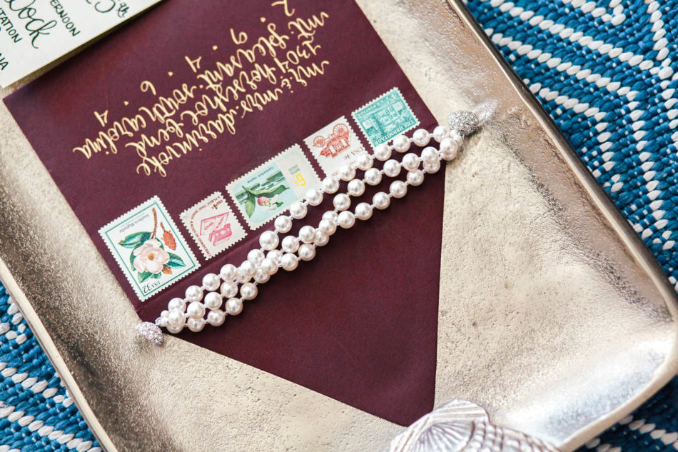 Invitation suite and jewelry lay on silver tray, Isle of Palms, Charleston, South Carolina. Kate Timbers Photography. http://katetimbers.com #katetimbersphotography // Charleston Photography // Inspiration