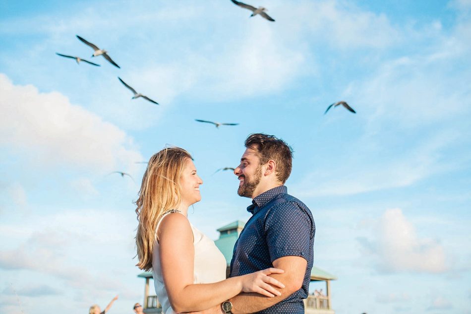 Engaged Couple has birds and blue skies above them, Folly beach in Charleston, South Carolina Kate Timbers Photography. http://katetimbers.com #katetimbersphotography // Charleston Photography // Inspiration