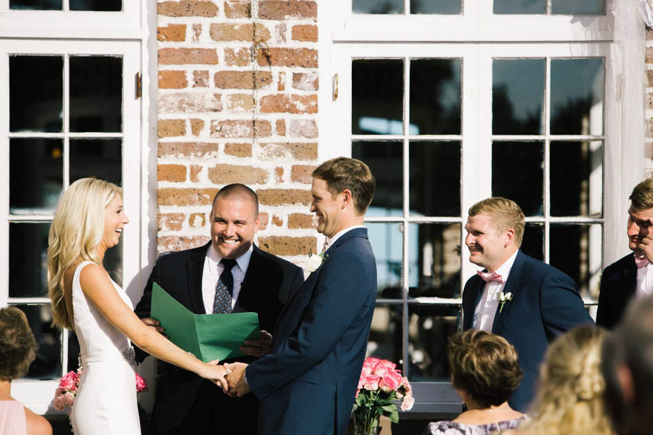 Bride and groom exchange vows, Rice Mill Building, Charleston, South Carolina Kate Timbers Photography. http://katetimbers.com #katetimbersphotography // Charleston Photography // Inspiration